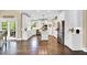 Bright kitchen features white cabinetry, stainless steel appliances, a center island, and hardwood flooring at 921 Riverwood Dr, Clayton, NC 27527