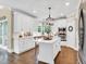 Stunning white kitchen with stainless steel appliances, a central island, and stylish pendant lighting at 921 Riverwood Dr, Clayton, NC 27527