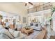 Open living room boasts a balcony, fireplace, hardwood floors, and views into the kitchen and dining areas at 921 Riverwood Dr, Clayton, NC 27527