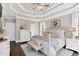 Inviting main bedroom with tray ceilings, dark wood floors, a sitting bench, and stylish neutral decor at 921 Riverwood Dr, Clayton, NC 27527