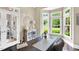 Bright office featuring a large desk, a bay window with green views, and decorative shelving with glass doors at 921 Riverwood Dr, Clayton, NC 27527
