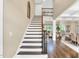Elegant home entryway featuring a staircase with wood and iron accents and hardwood floors at 921 Riverwood Dr, Clayton, NC 27527