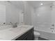 Bathroom features a shower-tub combo and a vanity with a dark wood cabinet at 100 Carol Cir # 17, Louisburg, NC 27549