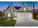Charming home featuring a two-car garage, stone accents, and a well-maintained lawn at 100 Carol Cir # 17, Louisburg, NC 27549