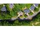 Aerial view of a home nestled among lush trees in a tranquil neighborhood with well-maintained properties at 101 Eden Glen Dr, Holly Springs, NC 27540