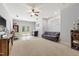 Spacious basement featuring plush carpet, a gray sofa, and ample natural light from a window and French doors at 101 Eden Glen Dr, Holly Springs, NC 27540