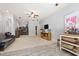 A well-lit basement with neutral carpet, hardwood floors, a comfy couch, and custom storage solutions for organization at 101 Eden Glen Dr, Holly Springs, NC 27540