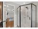 Updated bathroom with a black framed glass enclosed shower with tiled walls and brushed nickel shower head at 101 Eden Glen Dr, Holly Springs, NC 27540