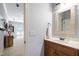 Bathroom with a single vanity, stylish mirror and entry to a bonus room at 101 Eden Glen Dr, Holly Springs, NC 27540