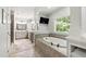 Relaxing bathroom with soaking tub, double vanity, tile flooring, and large window at 101 Eden Glen Dr, Holly Springs, NC 27540