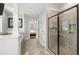 Stunning primary bathroom with glass shower, tile floors, and doorway to a bedroom at 101 Eden Glen Dr, Holly Springs, NC 27540