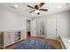 Spacious bedroom with light walls, hardwood floors, ceiling fan, and stylish furnishings at 101 Eden Glen Dr, Holly Springs, NC 27540