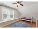 Bedroom featuring a unique daybed, hardwood floors and a window seat with natural light at 101 Eden Glen Dr, Holly Springs, NC 27540
