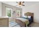 Cozy bedroom with natural light, bed, and a cool cartoon wall decoration at 101 Eden Glen Dr, Holly Springs, NC 27540
