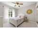 Charming bedroom with ceiling fan, bedside table, and natural light from a window at 101 Eden Glen Dr, Holly Springs, NC 27540