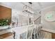 Elegant dining room with modern lighting, staircase, and hardwood floors, designed for stylish entertaining at 101 Eden Glen Dr, Holly Springs, NC 27540