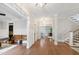 Elegant foyer with hardwood floors, a wooden bench, and decorative molding, creating a grand entrance at 101 Eden Glen Dr, Holly Springs, NC 27540