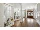 Elegant foyer with hardwood floors, staircase, and views into the dining room at 101 Eden Glen Dr, Holly Springs, NC 27540