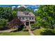 Charming two-story home with landscaped yard, flowering tree, and covered entry featuring beautiful decorative wreaths at 101 Eden Glen Dr, Holly Springs, NC 27540