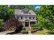 Charming two-story home with landscaped yard, flowering tree, and covered entry featuring beautiful decorative wreaths at 101 Eden Glen Dr, Holly Springs, NC 27540