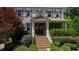 Close-up of the front porch with brick steps, decorative wreaths, and a well-manicured garden at 101 Eden Glen Dr, Holly Springs, NC 27540