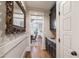 Hallway featuring beautiful dark cabinets with stainless steel sink and access to additional rooms at 101 Eden Glen Dr, Holly Springs, NC 27540