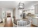Kitchen and eat-in-area with stainless appliances and white cabinets at 101 Eden Glen Dr, Holly Springs, NC 27540