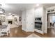 A kitchen flows into a living room with an open floorplan, fireplace, and built in shelving at 101 Eden Glen Dr, Holly Springs, NC 27540
