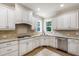 Well-lit kitchen featuring ample counter space, stainless steel appliances, and double windows at 101 Eden Glen Dr, Holly Springs, NC 27540