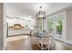 Eat-in kitchen featuring modern appliances, granite countertops, and access to the patio at 101 Eden Glen Dr, Holly Springs, NC 27540