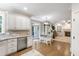 An open kitchen with stainless appliances, hardwood floors, and seamless access to the living area at 101 Eden Glen Dr, Holly Springs, NC 27540
