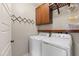 Laundry room featuring a side by side washer and dryer, storage cabinets and a place to hang clothes at 101 Eden Glen Dr, Holly Springs, NC 27540