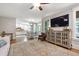 Open-concept living room showcasing hardwood floors and seamless flow to the kitchen at 101 Eden Glen Dr, Holly Springs, NC 27540