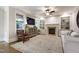Inviting living room featuring a fireplace, built-in bookshelves, and large windows at 101 Eden Glen Dr, Holly Springs, NC 27540