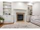 Fireplace with built-in shelving units in a modern and sleek living space at 101 Eden Glen Dr, Holly Springs, NC 27540
