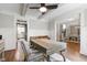 Spacious office with a ceiling fan and wainscoting, seamlessly flowing into the dining area and hallway at 101 Eden Glen Dr, Holly Springs, NC 27540