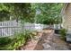 A verdant garden is bordered by a white picket fence with stepping stones to keep your feet mud-free at 102 Legacy Ln, Durham, NC 27713