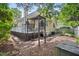 Enjoy outdoor living on this home's wooden deck and trellis and its peaceful landscaped yard at 102 Legacy Ln, Durham, NC 27713