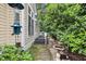 A stone path leads along the side of the home with mature landscaping and a bird bath at 102 Legacy Ln, Durham, NC 27713