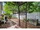 A unique trellis is featured in this backyard, along with stepping stones and a white picket fence at 102 Legacy Ln, Durham, NC 27713
