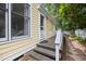 The back of the house features a porch with steps and a lovely stone walkway through the yard at 102 Legacy Ln, Durham, NC 27713