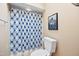 Bright full bathroom featuring a tiled floor, blue shower curtain, and modern fixtures at 102 Legacy Ln, Durham, NC 27713
