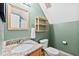 This bathroom features a granite countertop, decorative mirror, and built-in shelf for storage at 102 Legacy Ln, Durham, NC 27713