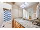 Well-lit bathroom with granite counters, light wood cabinets, and tile flooring and shower at 102 Legacy Ln, Durham, NC 27713