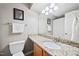 Bathroom with granite countertop, a large mirror, and a toilet at 102 Legacy Ln, Durham, NC 27713