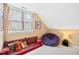 A brightly-lit bedroom with a beanbag chair and comfy seating area at 102 Legacy Ln, Durham, NC 27713