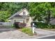 Charming yellow home featuring a manicured front yard, driveway, and lush trees at 102 Legacy Ln, Durham, NC 27713