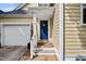 Inviting entryway showing a blue front door, white trim, and attached garage at 102 Legacy Ln, Durham, NC 27713