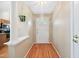 An inviting hallway leading to the front door, featuring hardwood floors at 102 Legacy Ln, Durham, NC 27713