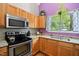 Kitchen features stainless steel appliances, light wood cabinets, and granite countertops at 102 Legacy Ln, Durham, NC 27713